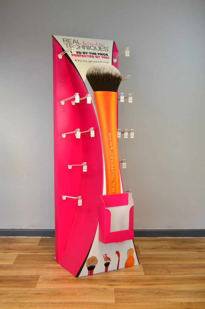 Hook tall display unit for merchandising multiple beauty products in a retail store