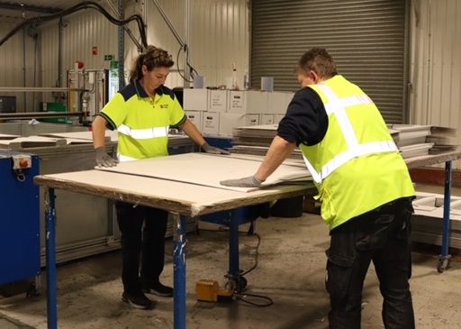 Members of the Co-packing team glueing and constructing an FSDU unit